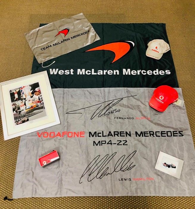 A selection of Mercedes McLaren promotional items to include three flags, two caps, a key ring,