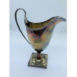 A silver jug on square base, makers mark EJH & NH