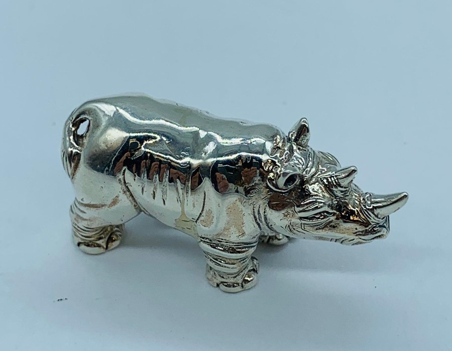 A silver figure of a Rhino