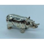 A silver figure of a Rhino