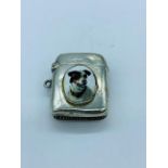 A silver vesta case with enamel plaque depicting a Dog