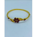A 22ct gold and Ruby bracelet with a floral motif.
