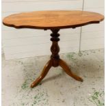 A serpentine top centre table with turned support to legs