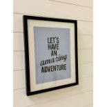 A framed poster "Let's Have An Amazing Adventure"