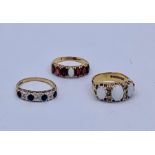 A selection of three 9ct gold rings with a variety of settings including Opal