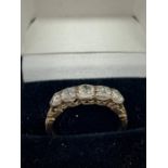 An 18ct yellow gold ring with five stone old cut Diamonds of 1ct approx.