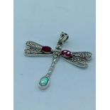 A silver Dragon Fly pendant necklace set with Ruby cabochons and Opal panelled tail