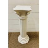 A white china plinth or plant stand.
