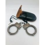 A Set of vintage Police hand cuffs in leather case.