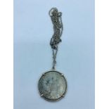 A Maria Theresa coin on a silver chain
