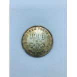 A 1000 yen coin 1964 Summer Olympics Tokyo.