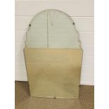 An arched wall hanging mirror