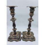 A pair of silver candlesticks, one AF, indistinct hallmarks