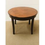 A small circular low table on tapered legs