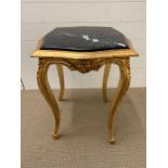 A gilt framed square marble occasional table