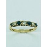 A 9ct gold ring set with four small Sapphires and three small Diamonds (1.58g)