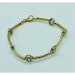 A 9ct yellow gold bracelet or anklet with Amethyst style stones (total weight is 5.77g)