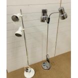 A white floor standing spot light by O.L and one floor standing chrome two independent spot light(