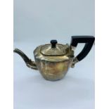 A Sterling silver Teapot with ebony style handle and ornate spout, total weight 795g