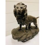 Bronzed figure of a Lion on a rock