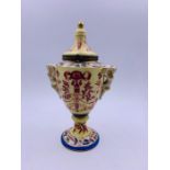 A lidded small vase, hand painted with cross sword mark to base
