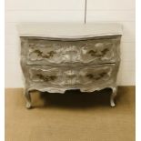 A French hand painted Serpentine style chest of drawers with two very large draws and ornate brass