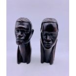 A pair of carved tribal heads