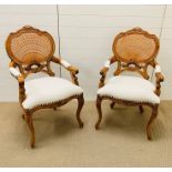 Two open armchairs with cane backs