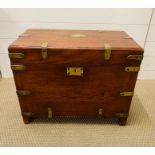 A campaign trunk on feet with protective brass straps and corners, brass name plate and Corry