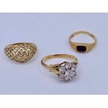 A selection of three 9ct gold rings with various stones and settings
