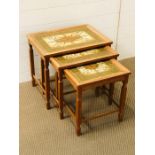 A nest of three tiled topped tables