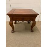 A square low table with metal ware detail to side (H59cm D61cm W71cm)
