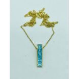 A 9ct gold necklace with pendant with Aquamarine style stones.