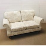 A Marks and Spencer "Salisbury AW14" two seater sofa in dioma floral natural fabric with wooden feet