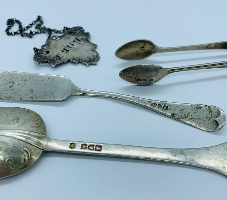 A selection of hallmarked silver items to include: a spoon, butter knife, sugar nips and a Port - Image 2 of 2