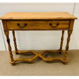 A pine console table with cross band stretcher