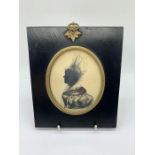 A framed silhouette miniature of a lady.