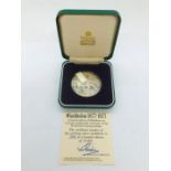 A Limited Edition Medallion by Garrard in Sterling Silver celebrating the Centenary of the Wimbledon