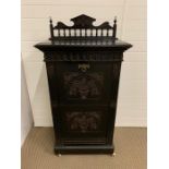 An Arts and Crafts ebony music cabinet
