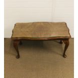 A small mahogany coffee table with flame mahogany and glass top and cabriole legs