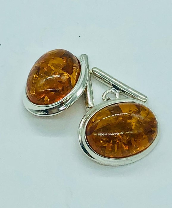 A pair of silver and amber style cufflinks