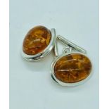 A pair of silver and amber style cufflinks