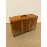 A vintage suitcase with wooden banding to sides