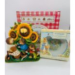 A boxed Oliver Otter and Friends sunflower clock along with a boxed Peter Rabbit china bowl