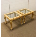 A pair of ornate cream and gold coffee tables with gilt detailing and fan decorations with