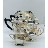 A selection of silver plated items to include a sauce boat, sugar bowl and pair of coffee pots.