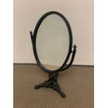 An oval table mirror on wrought iron frame with hand painted back