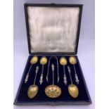 A boxed set of silver apostle spoons with sugar sifter