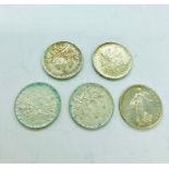 Five French Five Franc coins from the 1960's.