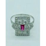A silver and cz art deco style ring with central ruby panel